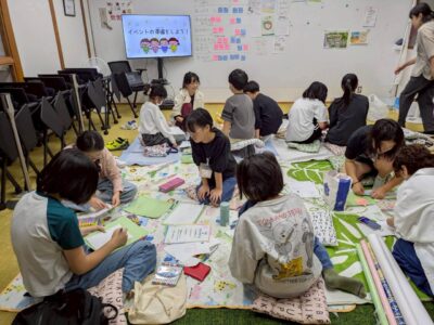 写真:室内でチームごとに話し合いを進める子どもたち。